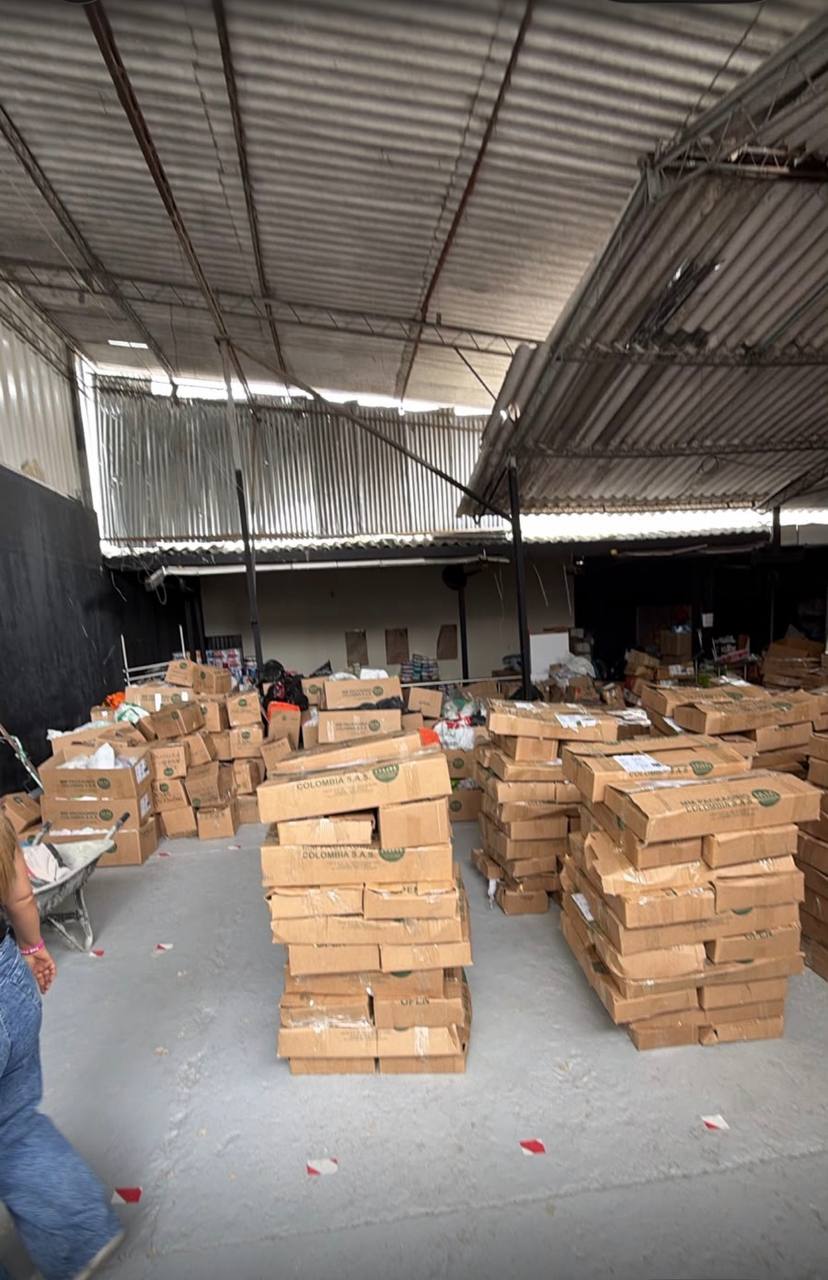 Boxes of food and medication stacked in a warehouse in Pereira, ready for distribution.